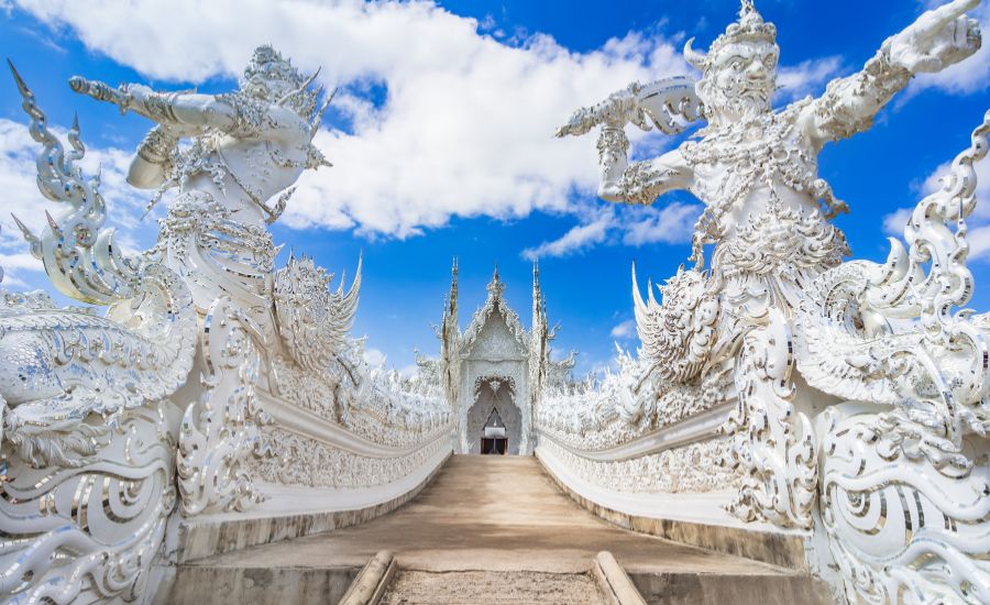 The striking, ornate entrance of Wat Rong Khun (White Temple) in Chiang Rai