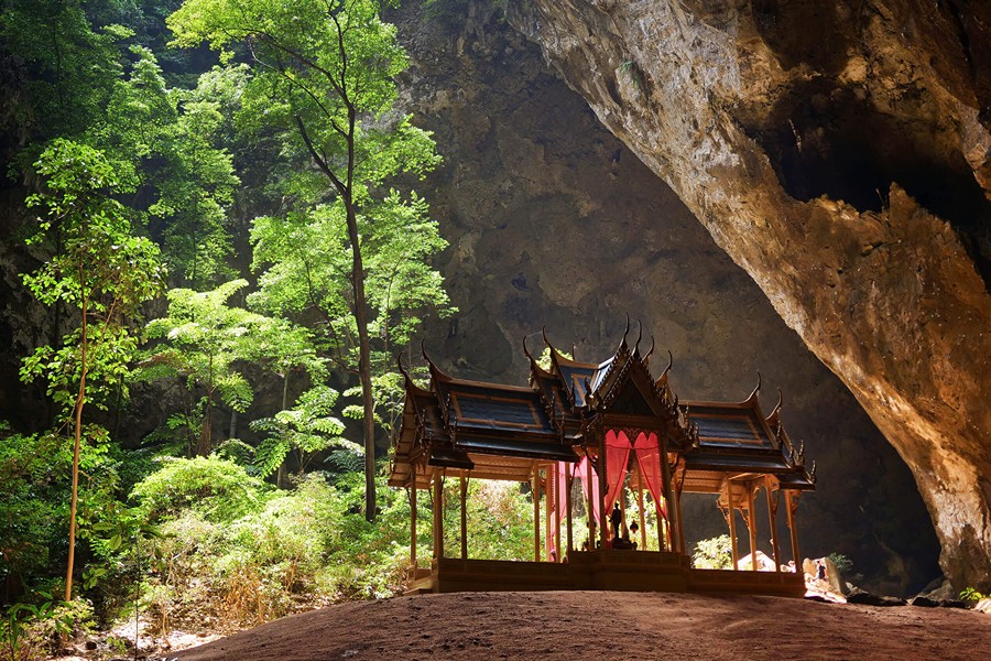 Sunlight illuminates the royal pavilion inside the dramatic Phraya Nakhon Cave.