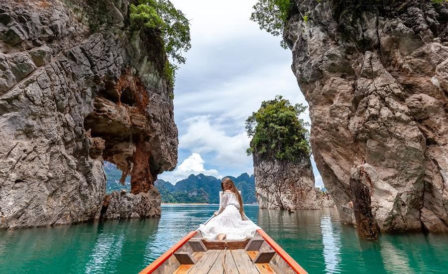 Limestone cliffs rise above the emerald water of Cheow Lan Lake in Surat Thani.