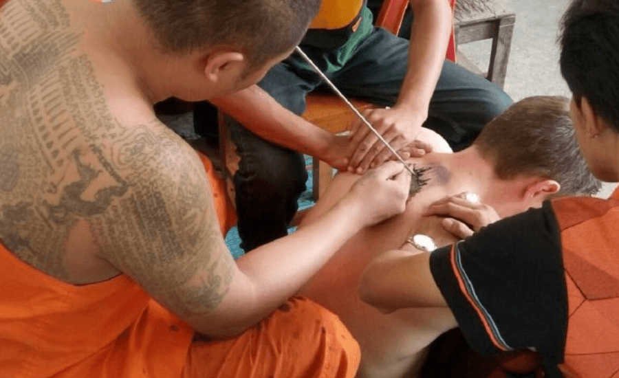 Monk performing Sak Yant