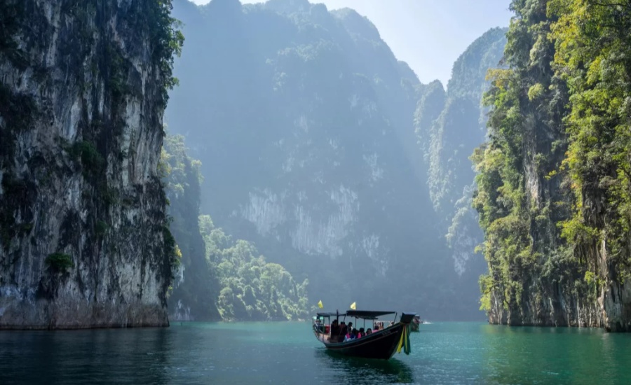 Scenic boat ride through Thailand's limestone cliffs.