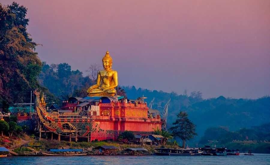 Golden Buddha statue by the Mekong River in Chiang Saen