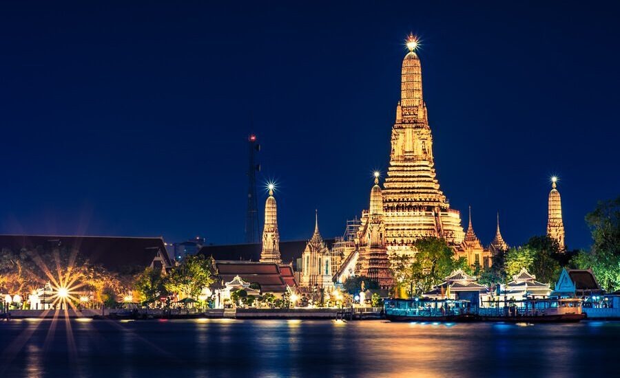 Wat Arun Temple illuminated in Thailand in January sky