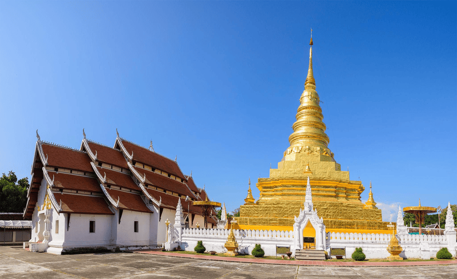 Golden stupa and hilltop setting at Wat Phra That Chae Haeng, Nan