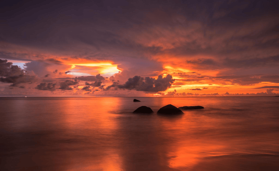 Sea beach with rainy cloud after sunset in rainy season in Phuket
