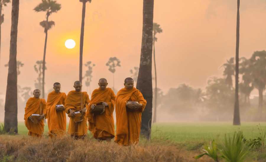 Buddhist monks go around to receive food from villagers in the morning in Thailand