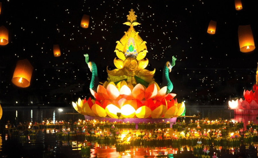 Giant illuminated float on water and sky lanterns.